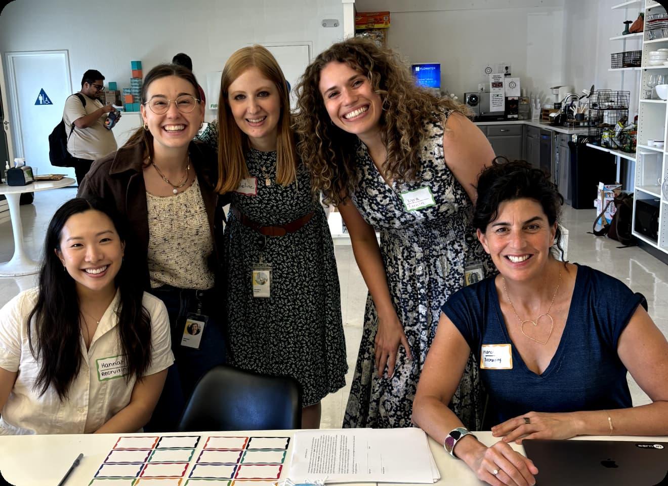 A woman and a man attaching a post-it to a glass wall in a brainstorm session